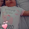 Essence is registered to the contest to win money with this photo: baby, infant, child, portrait, lying_down, pillow, bed, onesie, bow, pink, heart, sticker, date, indoor, close_up, face, dark_hair, serious_expression, cozy, photograph
