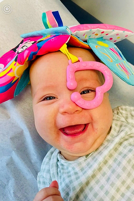 Brinley joined the competition — help win amazing prizes! baby, baby_laughing, baby_toddler_clothing, child, costume, event, fashion_accessory, fun, gesture, hair_accessory, happy, headgear, magenta, party_supply, pattern, peach, person, pink, smile, textile