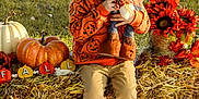 Braxton joined the competition — help win amazing prizes! child, boy, pumpkin_sweater, scarecrow_doll, hay_bale, fall_decorations, pumpkin, sunflowers, outdoor, grass, autumn, smiling, sitting, clothing, shoes, holiday, seasonal, festive, portrait, daylight
