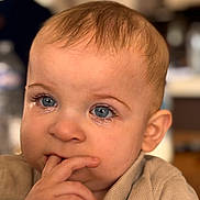 Lucas participe au concours pour gagner de l'argent avec cette photo : baby, infant, child, face, blue_eyes, tears, closeup, portrait, hand, finger_in_mouth, thoughtful, sad, eyelashes, skin, hair, clothing, indoor, shallow_depth_of_field, warm_tones, expression