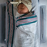 Samona joined the competition — help win amazing prizes! newborn, baby, sleeping, hospital, bassinet, blanket, bow_hat, swaddled, infant, cute, peaceful, portrait, child, resting, soft_lighting, hospital_bed, nursery, wrapped, closeup, adorable