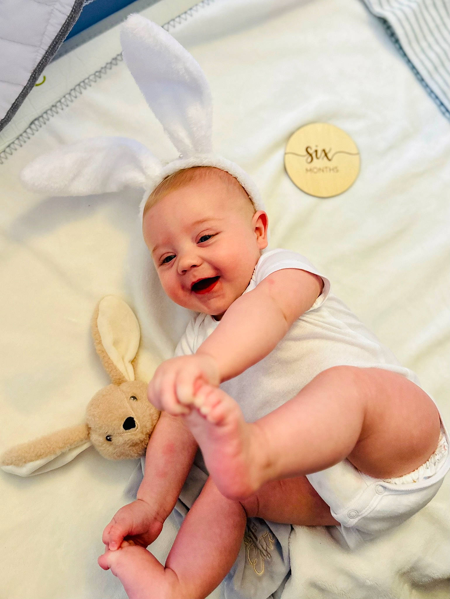 Quill is registered to the contest to win money with this photo: baby, baby_products, baby_toddler_clothing, child, comfort, event, finger, gesture, happy, insect, linens, peach, person, pink, product, smile, t_shirt, textile, thumb, toddler