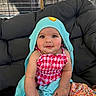 Oaklynn joined the competition — help win amazing prizes! baby, child, towel, hooded_towel, pink_clothing, checkered_pattern, cushion, chair, indoors, cute, smiling, face, skin, hand, foot, person, blue, yellow, plush, seated