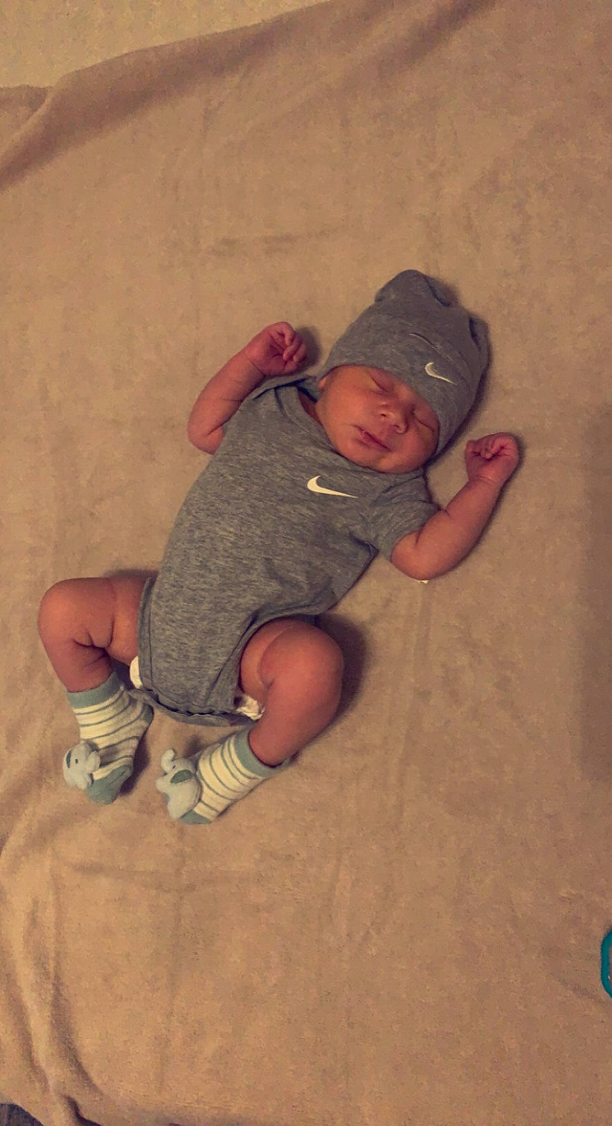 Marlo is registered to the contest to win money with this photo: baby, baby_toddler_clothing, baseball_cap, cap, child, comfort, crawling, elbow, face, floor, flooring, fun, hardwood, headwear, linens, pattern, person, sitting, sleeve, t_shirt