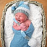 newborn, baby, infant, wrapped, blue_wrap, knit_hat, basket, blanket, soft_texture, sleepy, cute, tiny_hands, cozy, portrait, indoors, baby_bedding, headwear, sleeping, child, newborn_photography