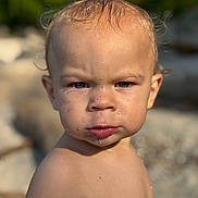 Daelen joined the competition — help win amazing prizes! toddler, child, face, portrait, outdoor, skin, water_droplet, sand, serious_expression, blond_hair, blue_eyes, bare_chest, sunlight, nature, closeup, person, summer, young_child, head_and_shoulders, curly_hair