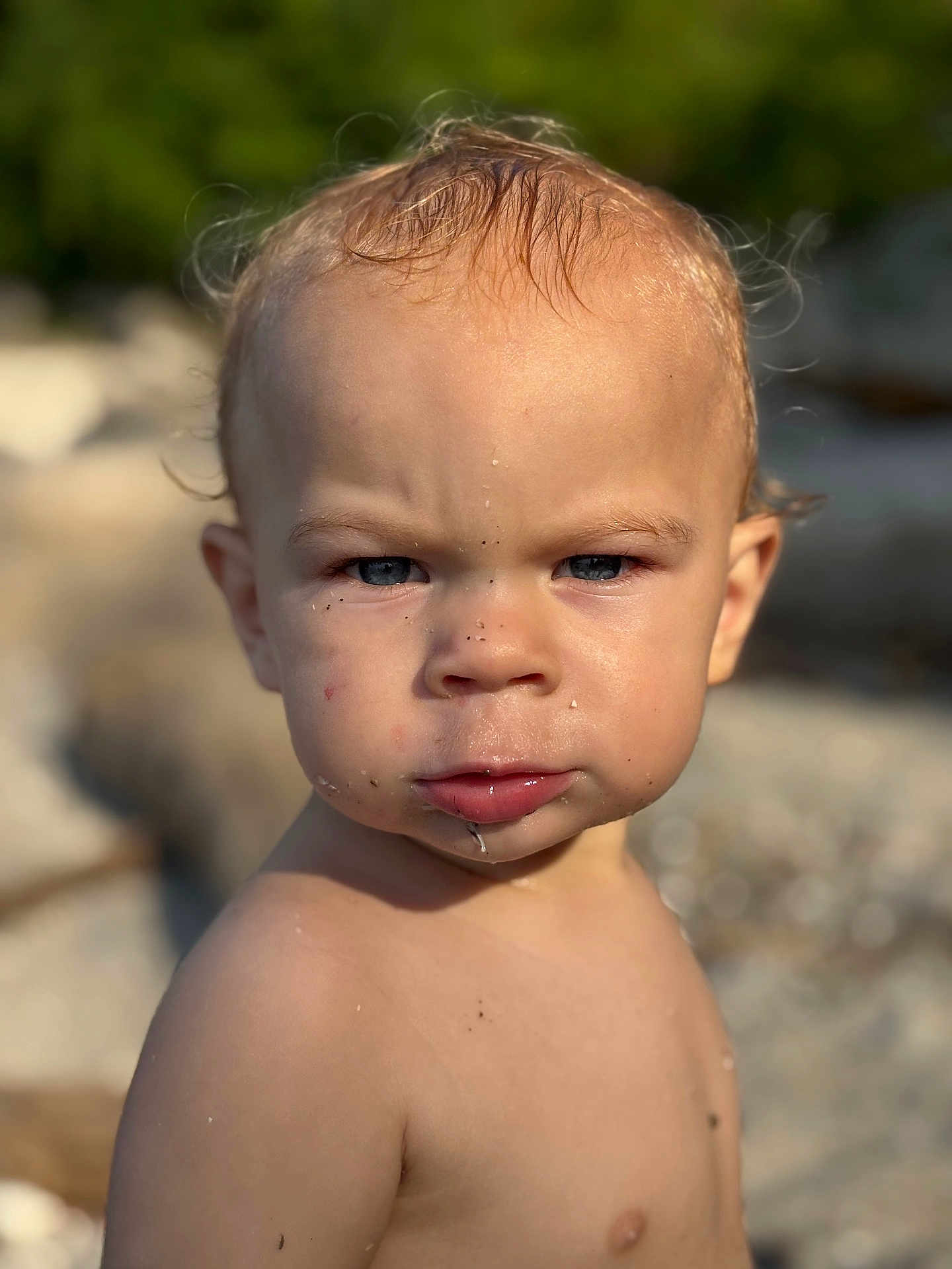Daelen joined the competition — help win amazing prizes! toddler, child, face, portrait, outdoor, skin, water_droplet, sand, serious_expression, blond_hair, blue_eyes, bare_chest, sunlight, nature, closeup, person, summer, young_child, head_and_shoulders, curly_hair