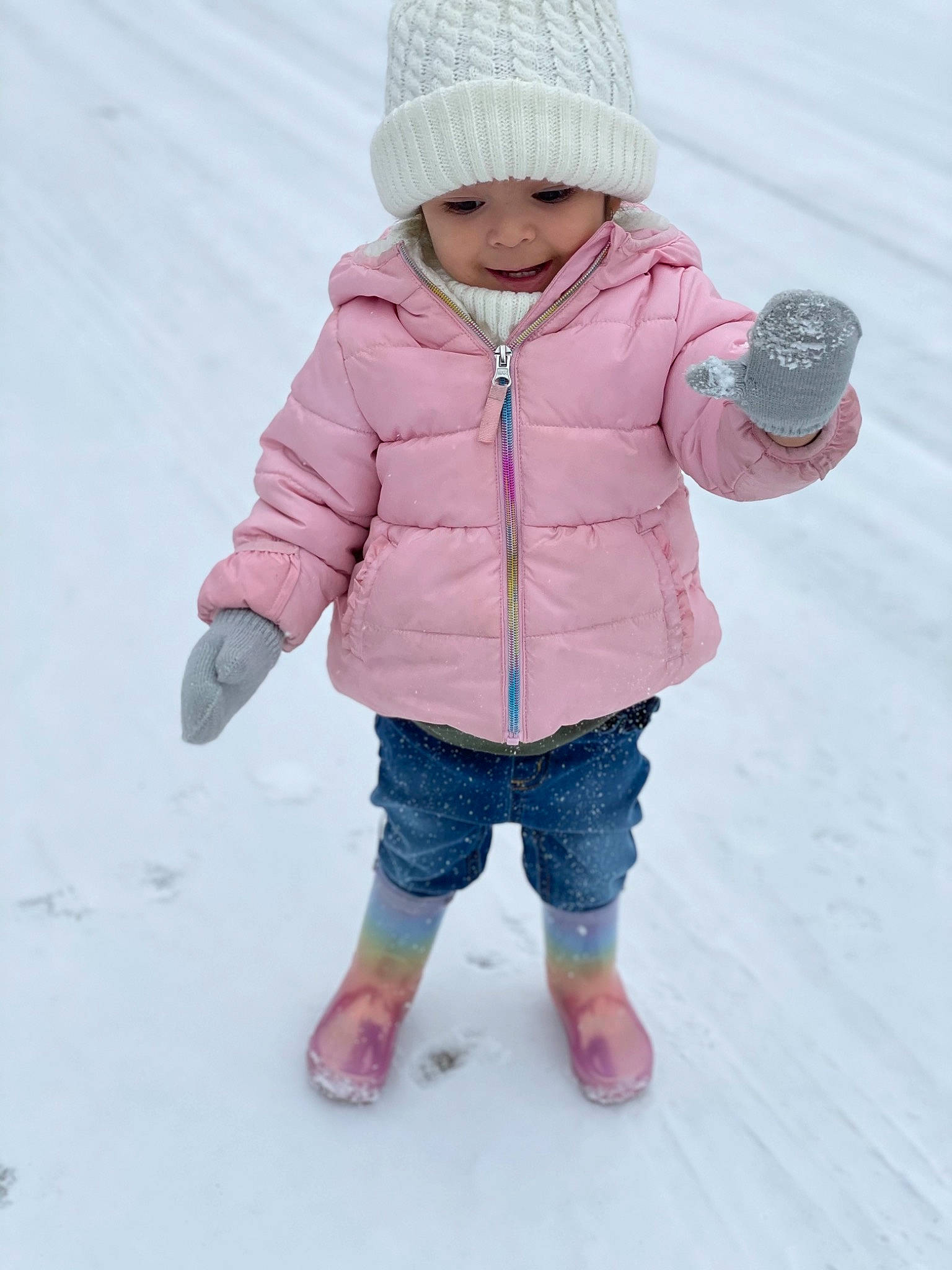 Camila joined the competition — help win amazing prizes! baby, baby_toddler_clothing, cap, cheek, child, clothing, freezing, gesture, headwear, hood, human_body, jacket, knit_cap, leg, outerwear, person, pink, sleeve, snow, toddler