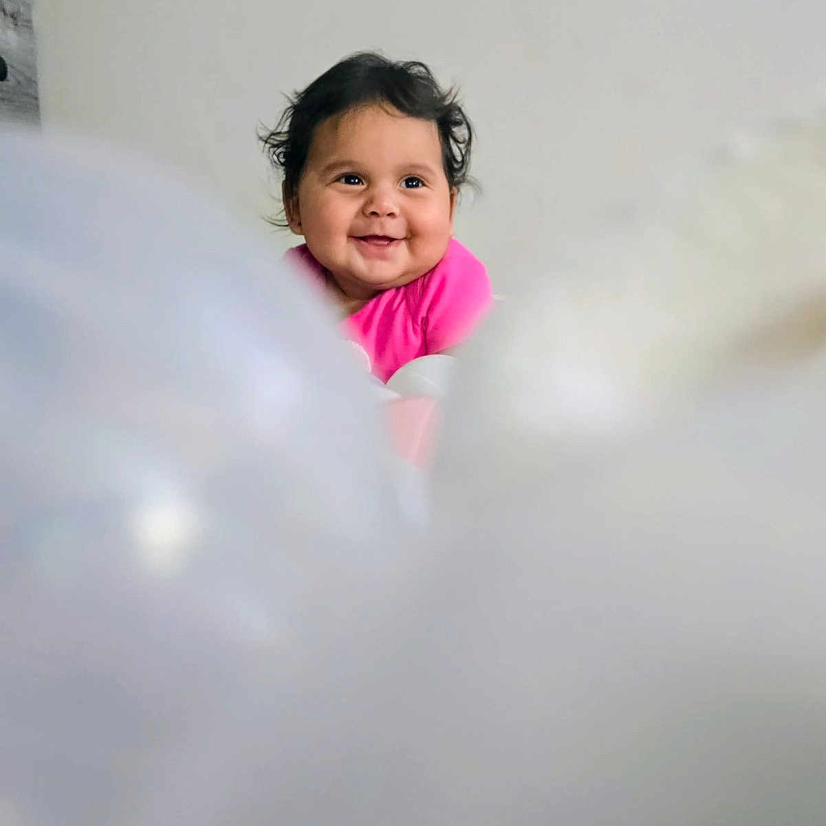 Sandra I Quintanilla joined the competition — help win amazing prizes! baby, background, blurry_foreground, child, curly_hair, cute, expression, face, happy, head, human, indoor, infant, joy, person, pink_clothing, portrait, smile, soft_focus, young_child