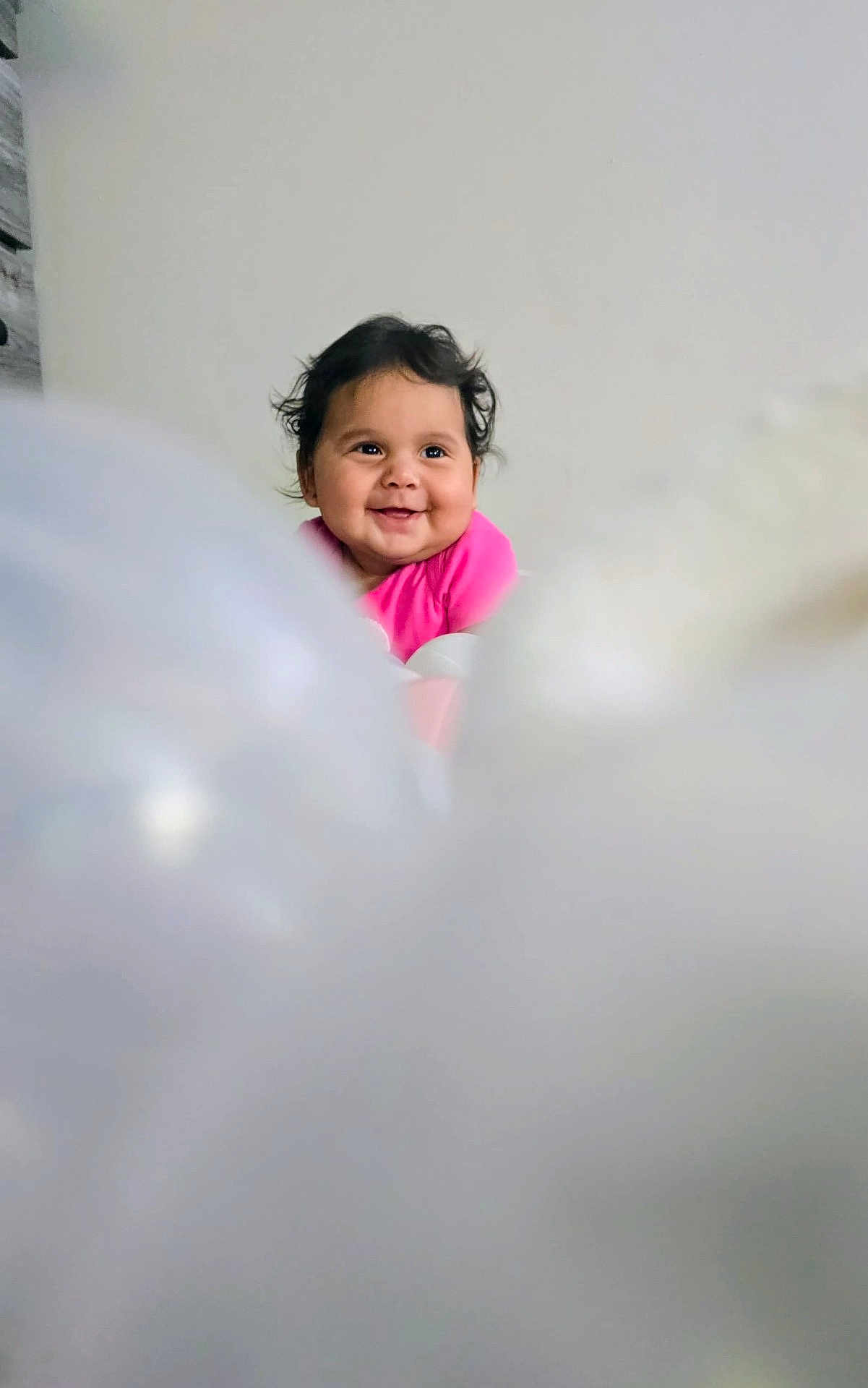 Sandra I Quintanilla joined the competition — help win amazing prizes! baby, child, smile, pink_clothing, curly_hair, portrait, indoor, happy, face, cute, infant, young_child, expression, human, person, background, soft_focus, blurry_foreground, joy, head
