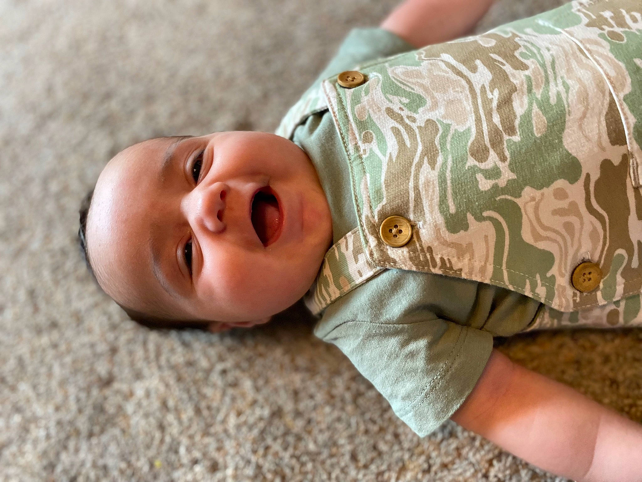 Cason is registered to the contest to win money with this photo: baby, baby_toddler_clothing, cheek, child, elbow, eye, gesture, grass, hand, happy, head, human_body, linens, neck, nose, person, skin, sleeve, smile, toddler