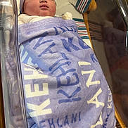 Kehlani joined the competition — help win amazing prizes! newborn, baby, sleeping, blanket, hat, bow, hospital, bassinet, sleep, infant, striped, cozy, resting, cute, child, swaddled, bed, comfort, soft, peaceful