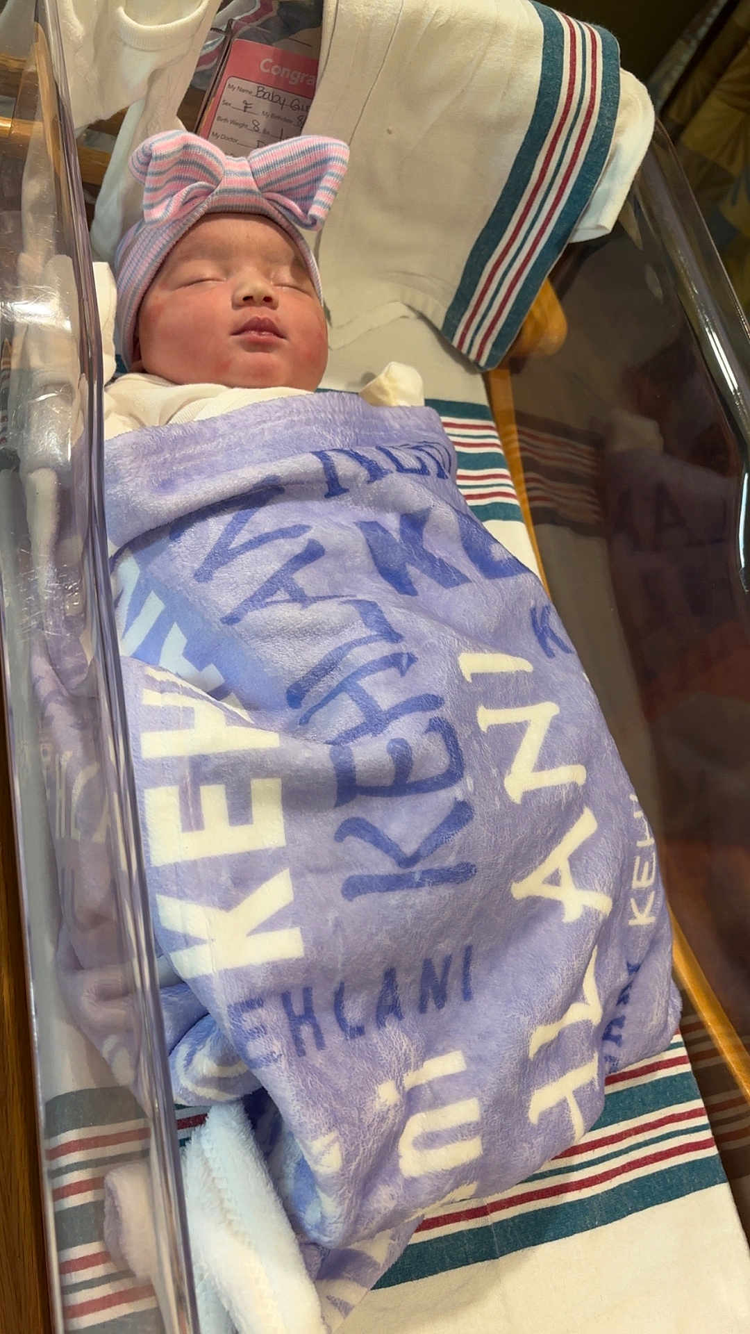 Kehlani joined the competition — help win amazing prizes! newborn, baby, sleeping, blanket, hat, bow, hospital, bassinet, sleep, infant, striped, cozy, resting, cute, child, swaddled, bed, comfort, soft, peaceful
