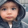 Isâac a rejoint le concours — aidez-le/la à gagner de superbes lots ! child, toddler, hoodie, grey_clothing, adidas, hood, face, expression, curious, hand, crumb, portrait, young_child, casual_wear, outdoor, closeup, person, cute, big_eyes, zipper