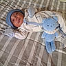 newborn, baby, sleeping, infant, portrait, bed, blanket, checkered, plush_toy, stuffed_animal, blue_toy, onesie, mittens, hat, clothing, cozy, indoors, nursery, lying_down, peaceful