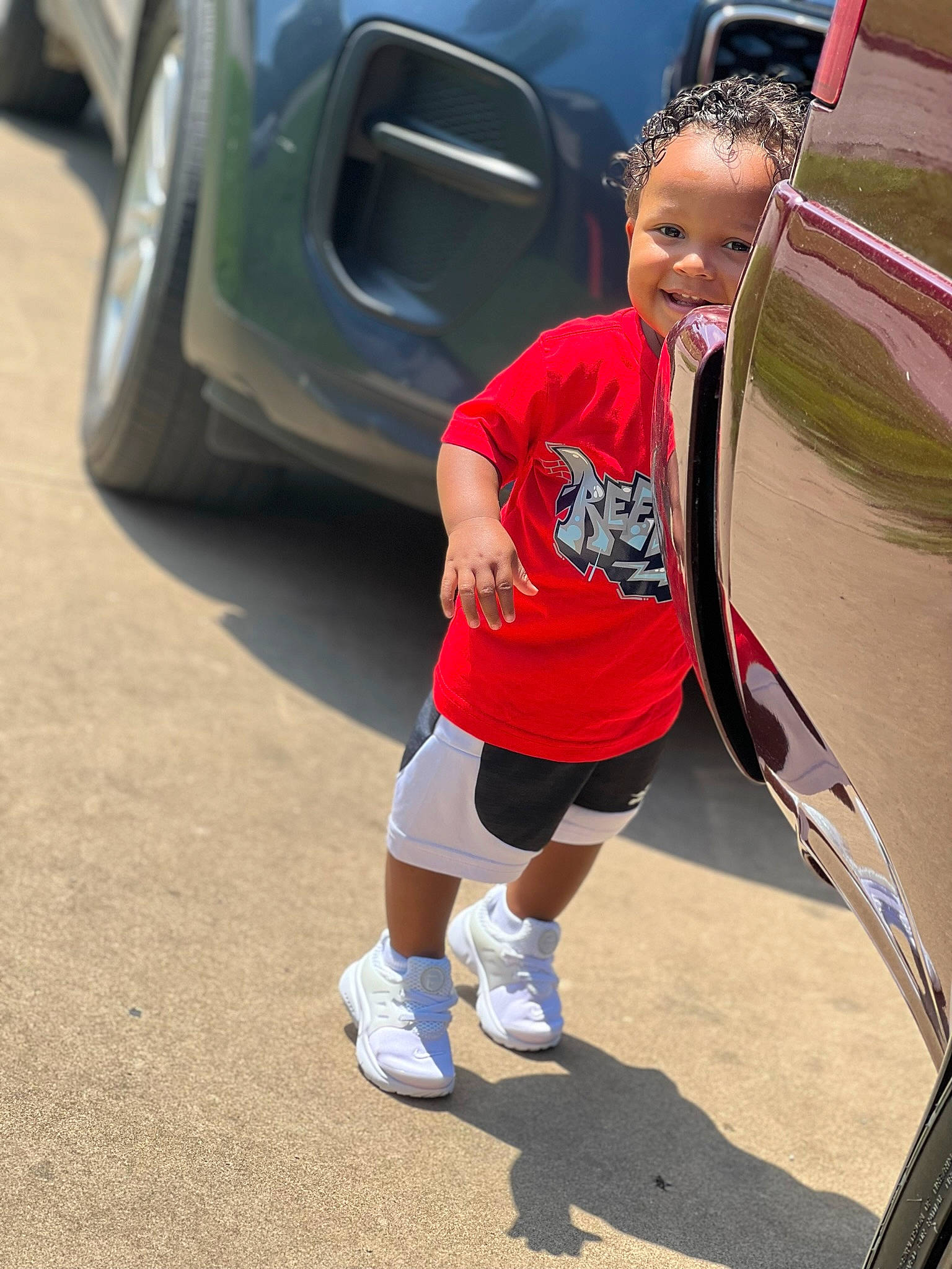 Deonte joined the competition — help win amazing prizes! asphalt, automotive_design, automotive_exterior, automotive_lighting, automotive_tire, automotive_wheel_system, bumper, car, hood, joy, leg, leisure, motor_vehicle, person, recreation, rim, shorts, sneakers, t_shirt, toddler