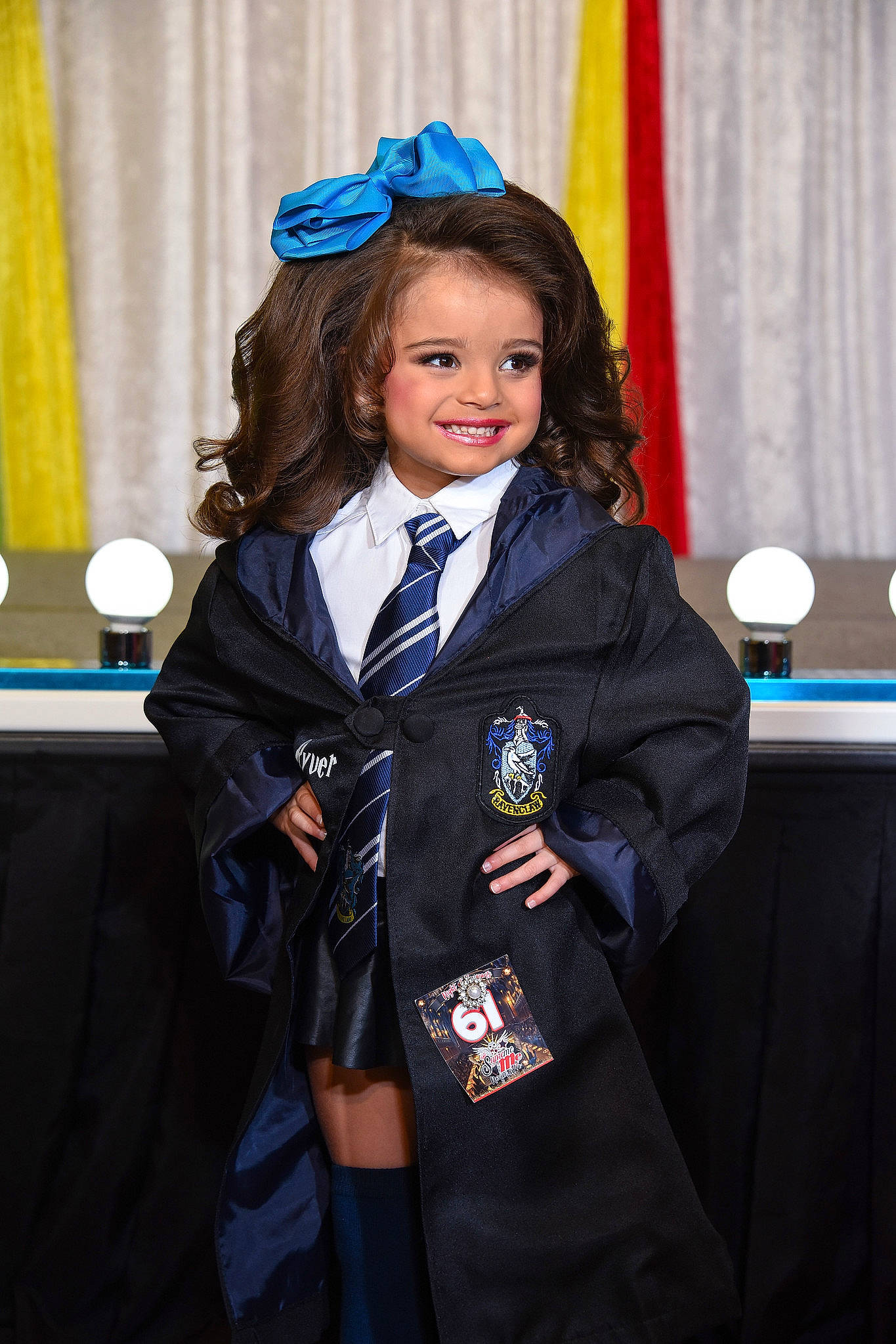 Ryver is registered to the contest to win money with this photo: blazer, child, curtain, electric_blue, event, fashion, fashion_design, formal_wear, fun, gesture, joy, military_officer, military_uniform, official, person, room, school_uniform, smile, street_fashion, tie