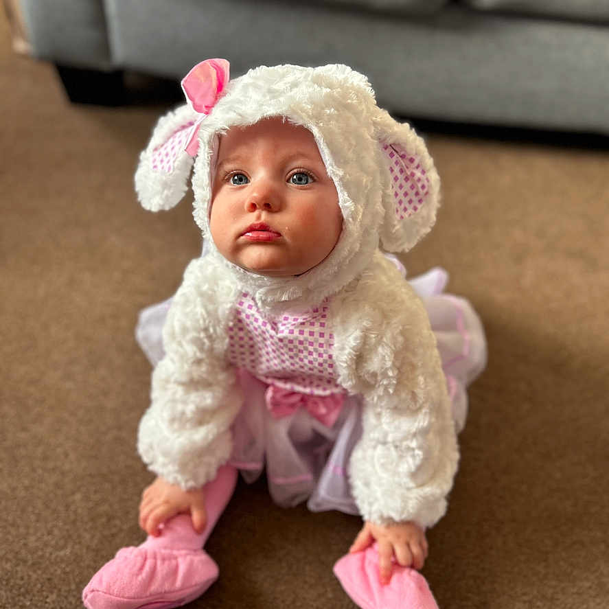 Daisy joined the competition — help win amazing prizes! baby, beanie, bonnet, cap, clothing, couch, face, footwear, furniture, hat, head, hood, newborn, person, photography, portrait, shoe, sitting, sunhat, toy