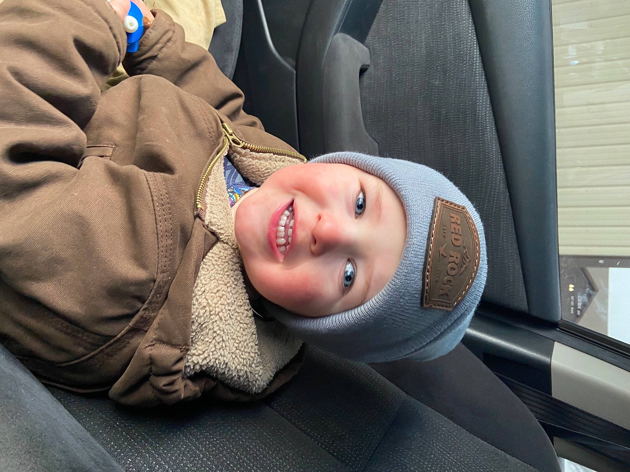 Grayson joined the competition — help win amazing prizes! auto_part, automotive_design, automotive_exterior, cap, car_seat, child, comfort, eye, flash_photography, fun, happy, hat, headgear, headwear, joy, motor_vehicle, person, smile, toddler, travel