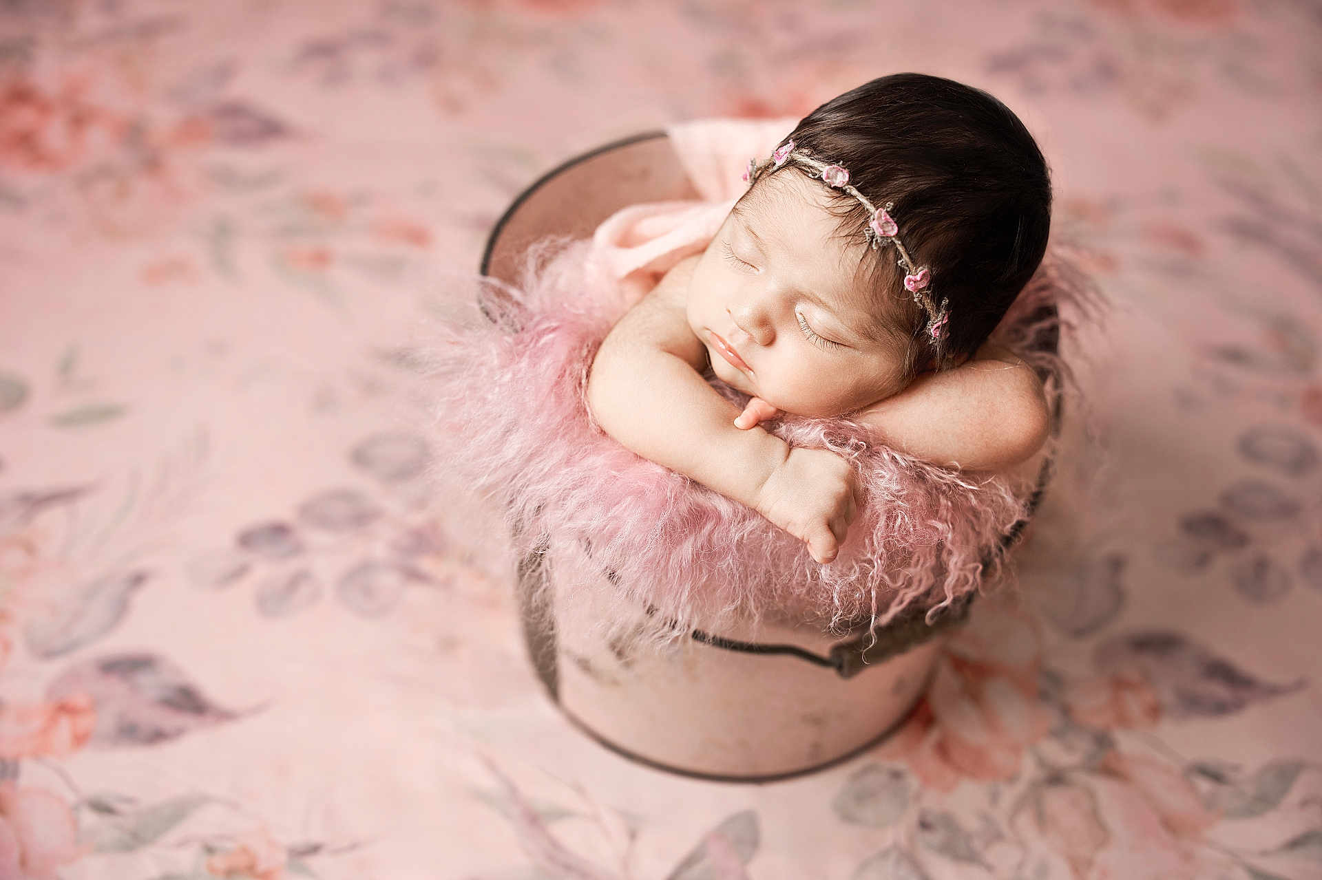 Eliana is registered to the contest to win money with this photo: newborn, baby, sleeping, pink, fluffy, bucket, headband, flower, soft, portrait, cute, infant, peaceful, resting, skin, arms, closeup, indoors, decor, gentle