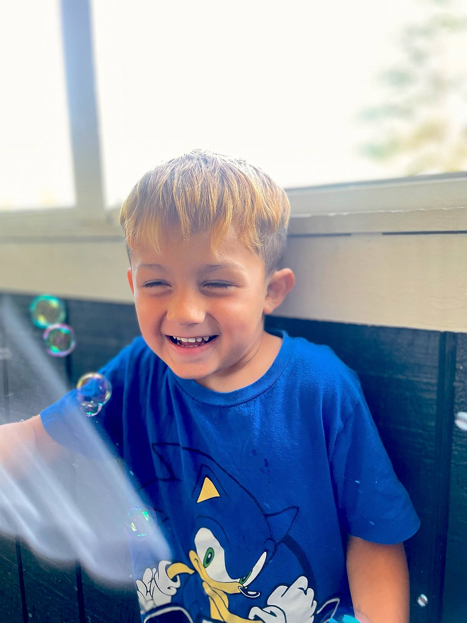 Dominick is registered to the contest to win money with this photo: child, electric_blue, fun, grass, happy, joy, laugh, leisure, ocean, person, play, portrait_photography, recreation, sitting, sky, sleeve, smile, t_shirt, toddler, top