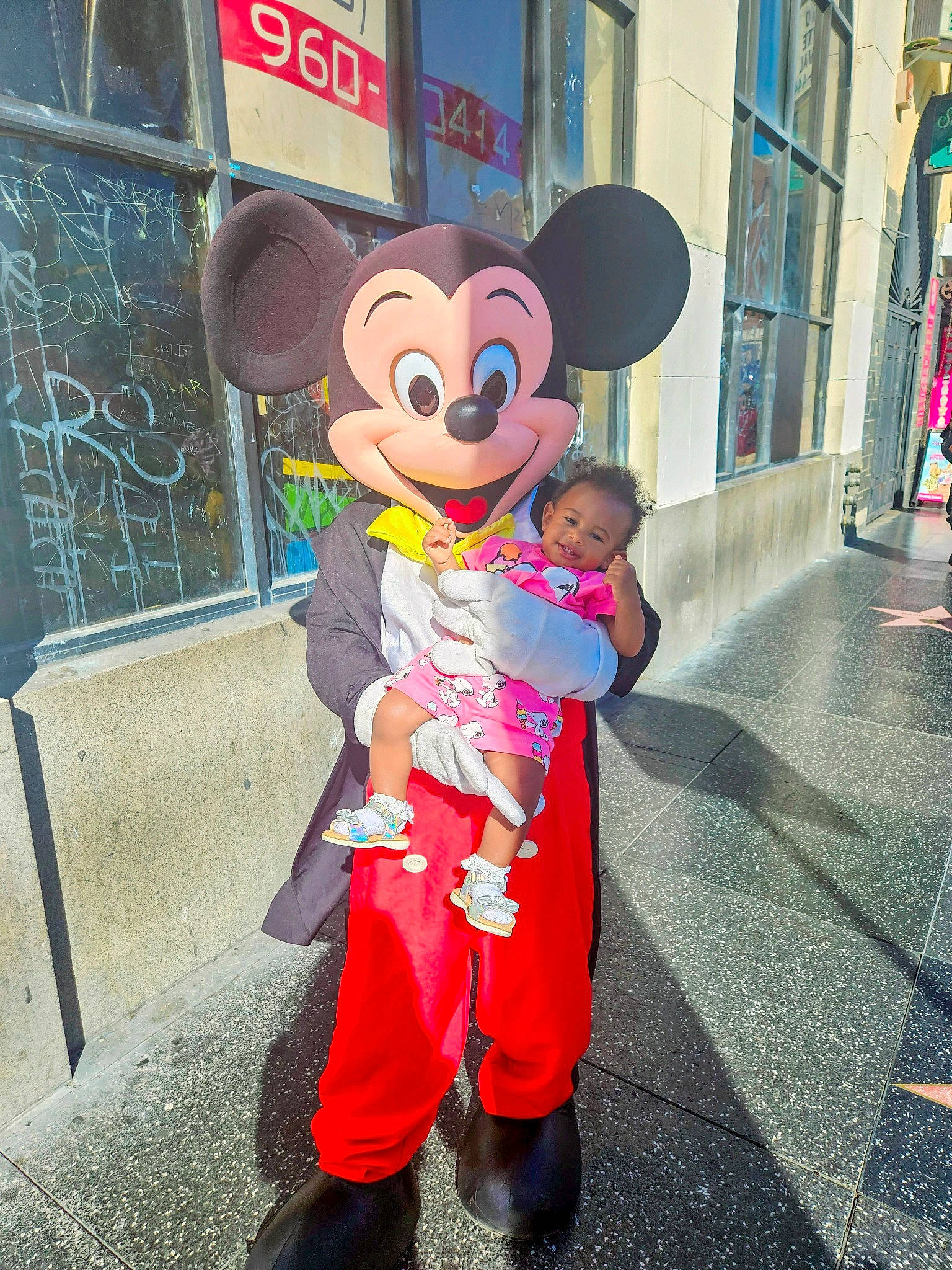 Lovely is registered to the contest to win money with this photo: animated_cartoon, child, costume, event, fun, fur, gesture, happy, hat, joy, leisure, magenta, mascot, person, pink, recreation, smile, sun_hat, toddler, travel