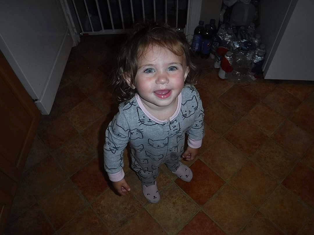 Natalia is registered to the contest to win money with this photo: cheek, child, eye, face, facial_expression, floor, flooring, fun, hardwood, head, iris, joy, leg, mouth, nose, organ, person, room, skin, smile