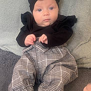 Mayleigh is registered to the contest to win money with this photo: baby, black_headband, black_top, blanket, calm_expression, child, comfortable, cozy, cute, fashion, headwear, indoor, infant, plaid_pants, portrait, sitting, small_hands, soft_texture, white_socks, young_child
