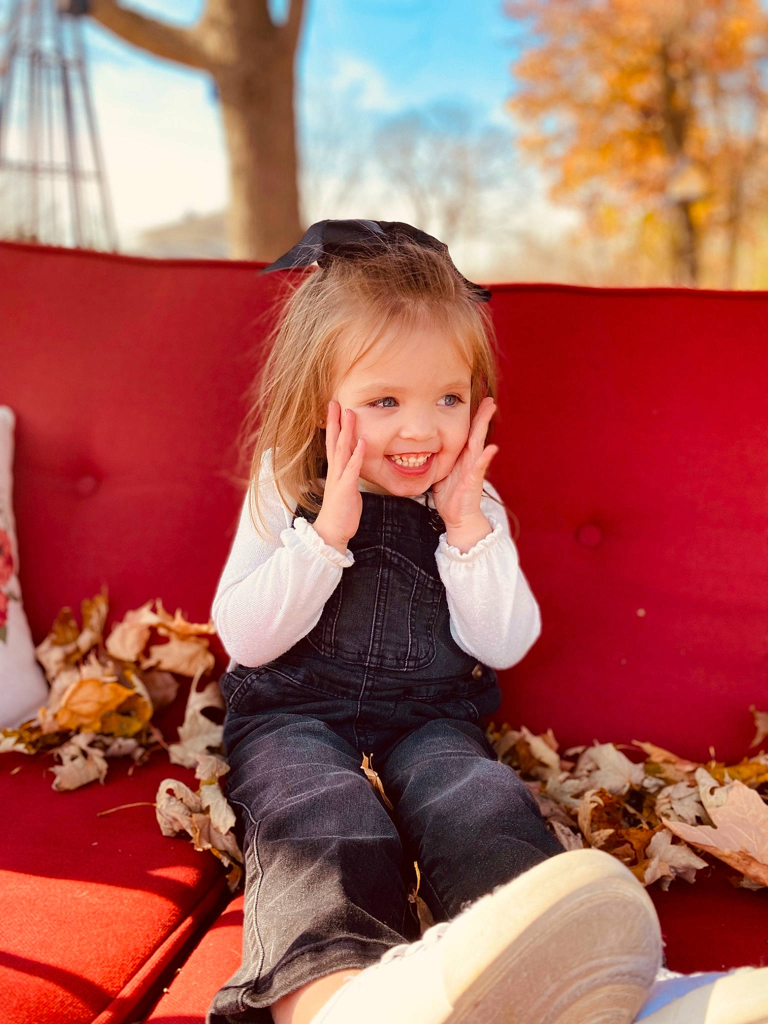 Ella Rae is registered to the contest to win money with this photo: beauty, blond, brown_hair, child, flash_photography, fun, happy, jeans, joy, knee, leisure, orange, people_in_nature, person, photograph, sitting, sky, smile, toddler, tree