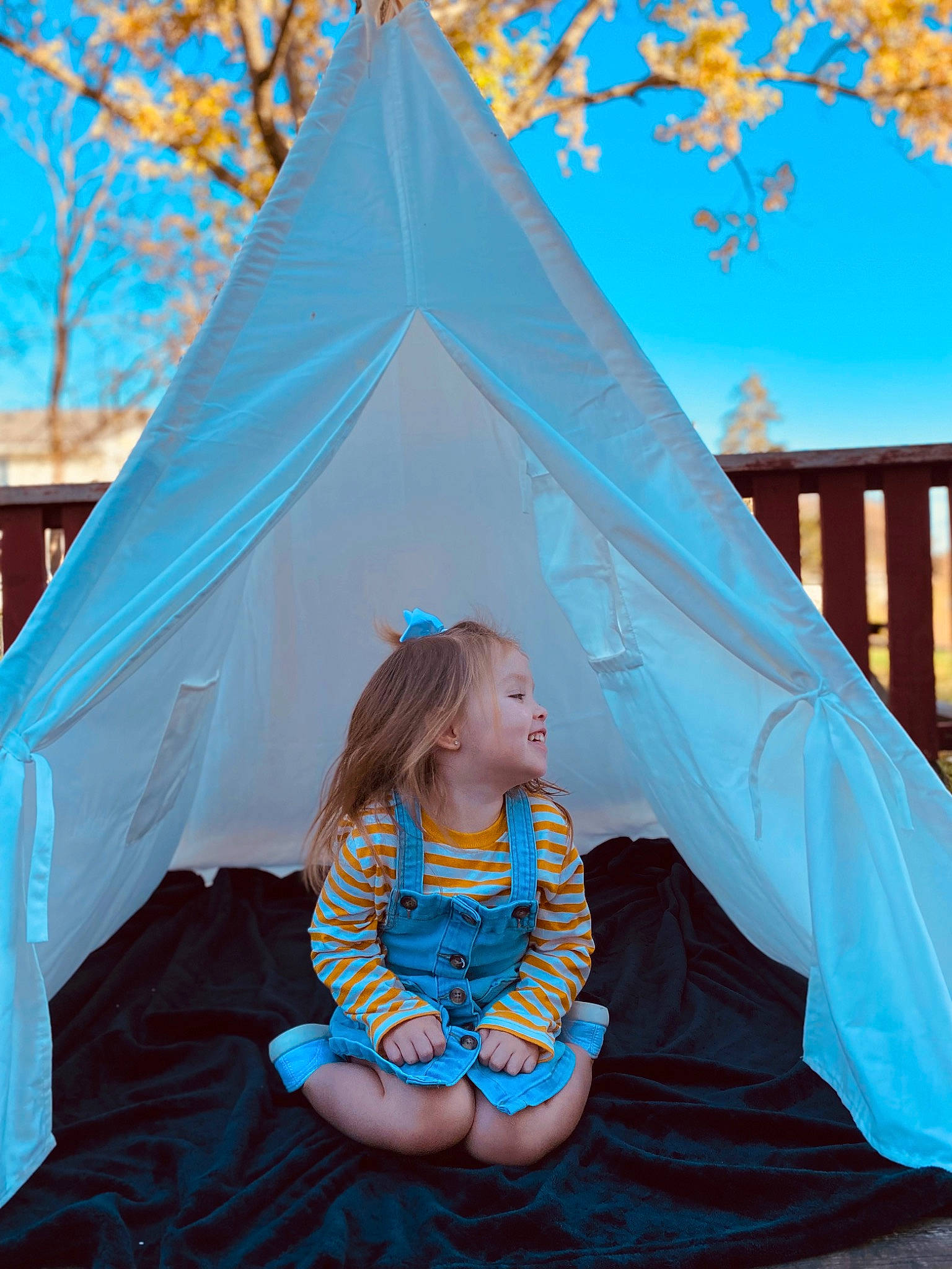 Ella Rae is registered to the contest to win money with this photo: blue, child, daytime, facial_expression, fun, grass, green, happy, leaf, leisure, morning, outerwear, people_in_nature, person, photograph, plant, public_space, shade, summer, toddler