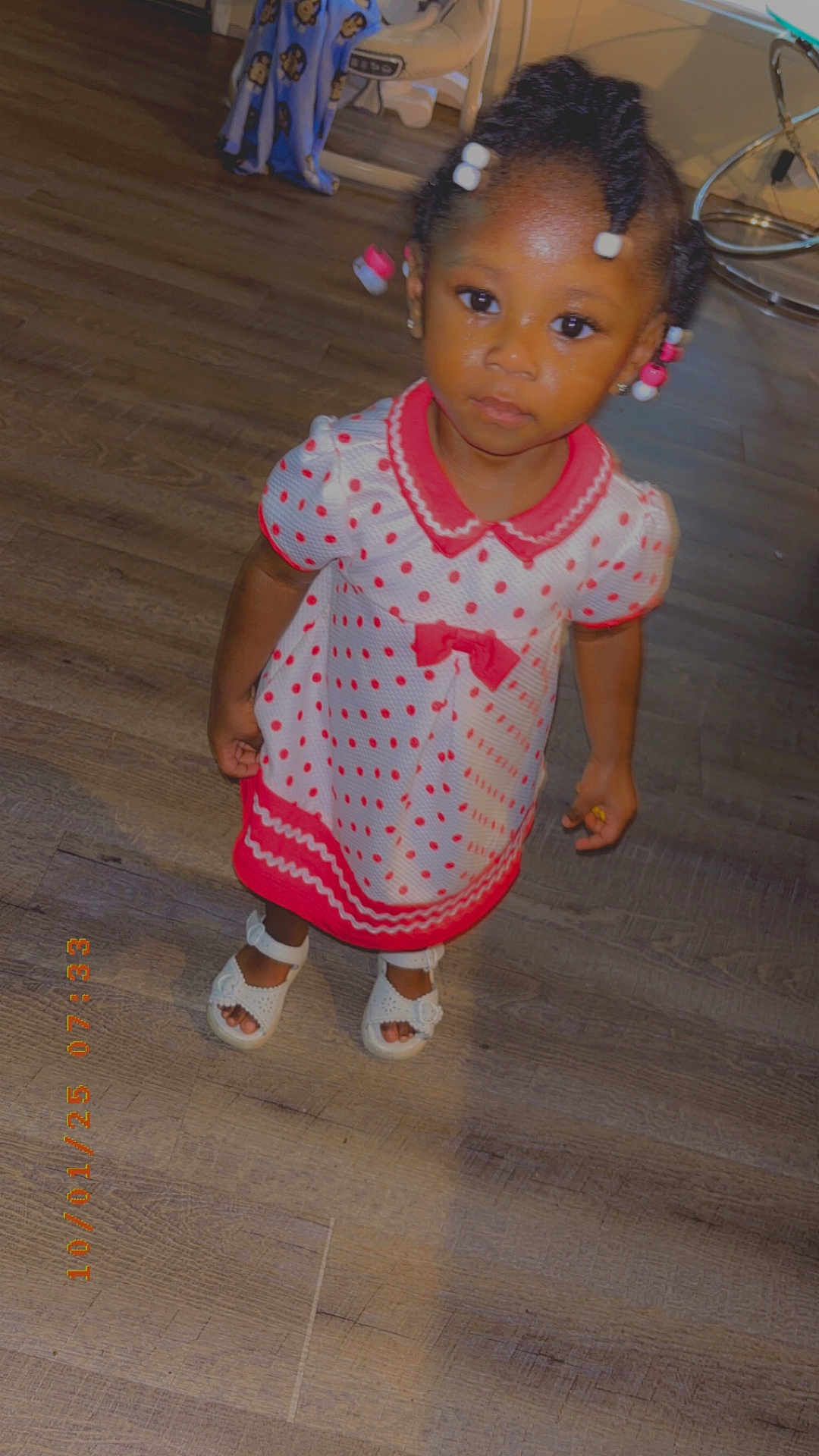 Amirica joined the competition — help win amazing prizes! child, toddler, dress, polka_dot, pink, white_shoes, beads, hair, floor, indoor, wooden_floor, curious, looking_up, standing, footwear, clothing, person, cute, portrait, young_child