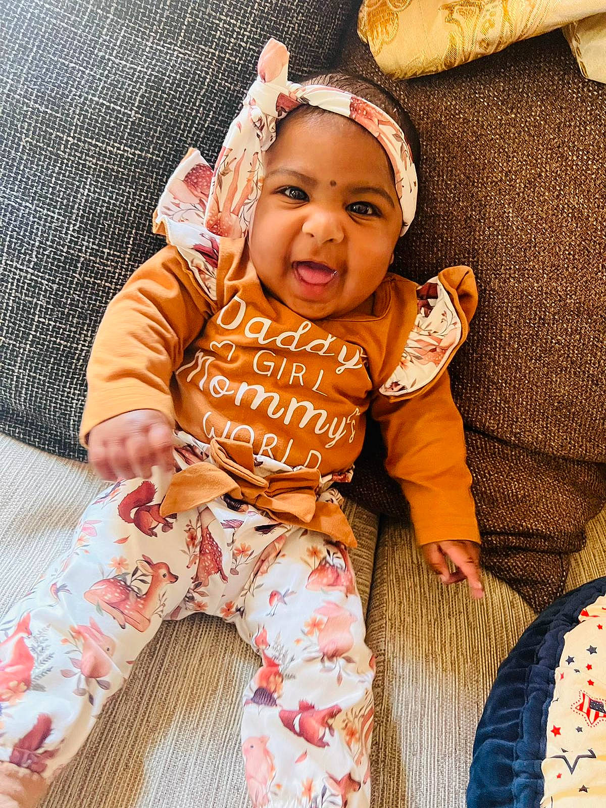 Amaya is registered to the contest to win money with this photo: baby, baby_sleeping, baby_toddler_clothing, child, comfort, flooring, fun, happy, linens, orange, pattern, peach, person, portrait_photography, room, sitting, skin, sleeve, t_shirt, toddler