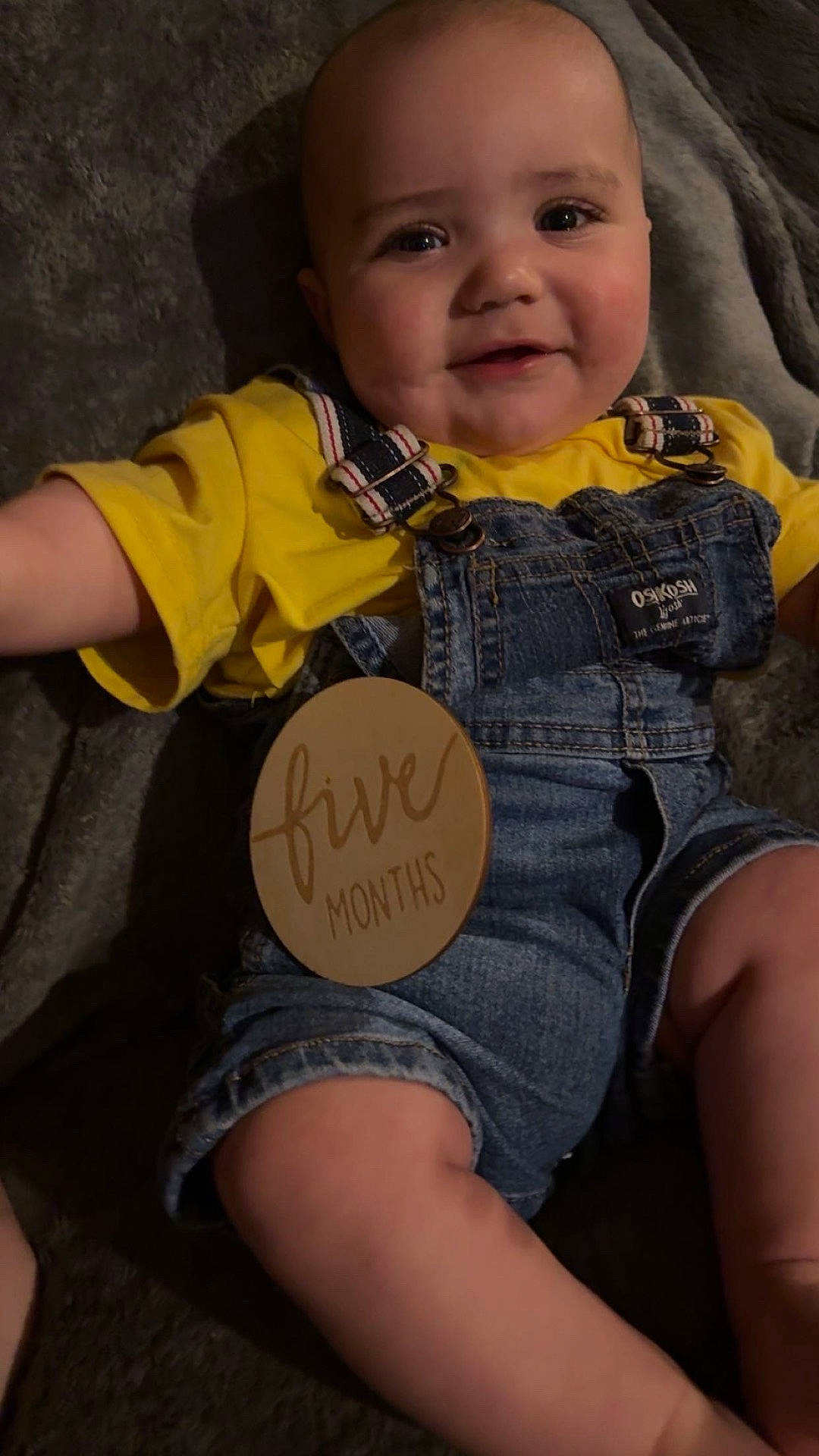 Jackson Ferrell is registered to the contest to win money with this photo: accessories, baby, clothing, coat, couch, face, furniture, happy, head, jacket, jeans, pants, person, photography, portrait, shorts, sitting, smile, t_shirt, vest