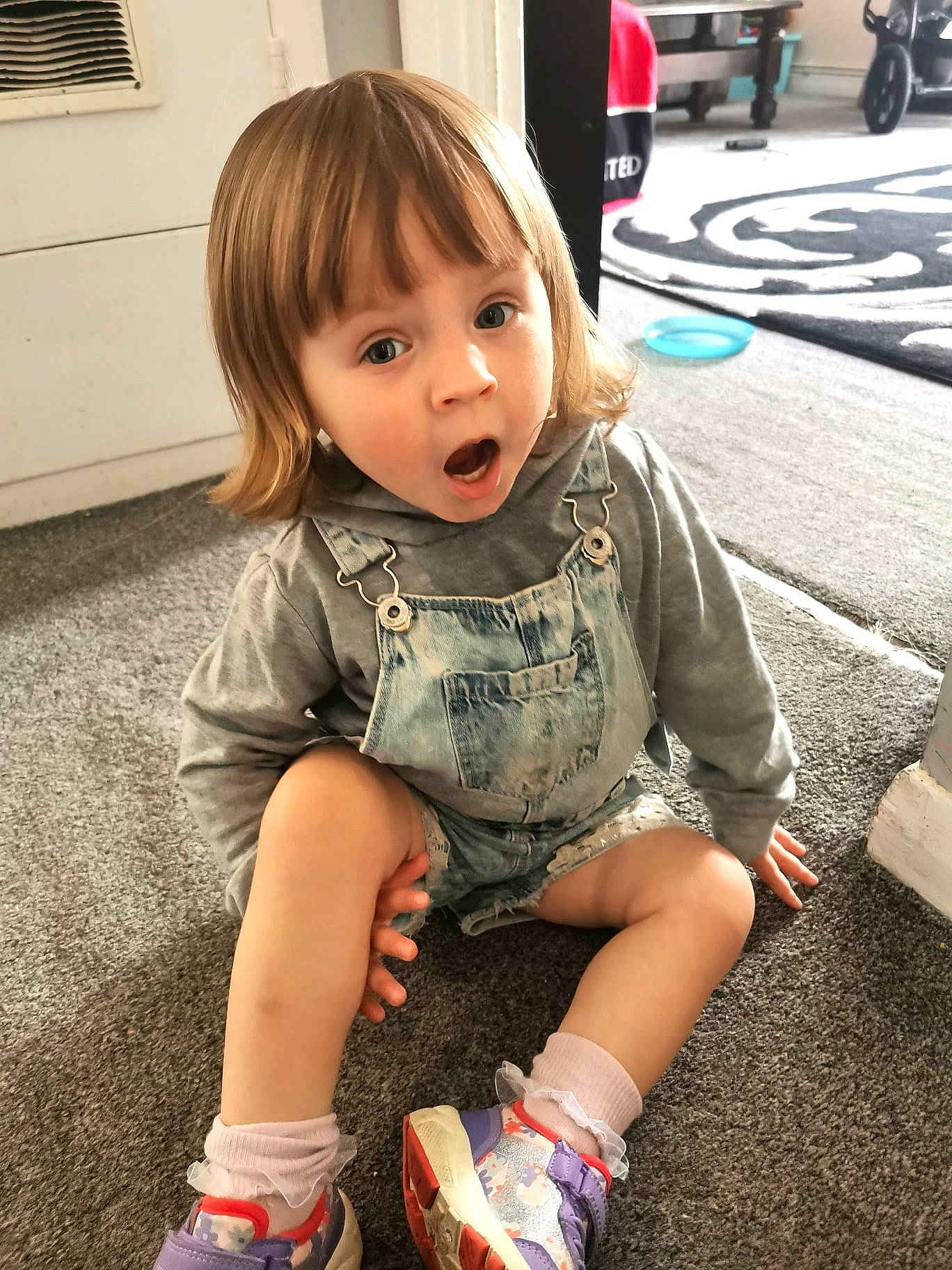Orla is registered to the contest to win money with this photo: baby, baby_toddler_clothing, beauty, flooring, fun, hair, happy, human_leg, iris, leg, person, shoe, shorts, sitting, sleeve, smile, snapshot, summer, surprise, toddler