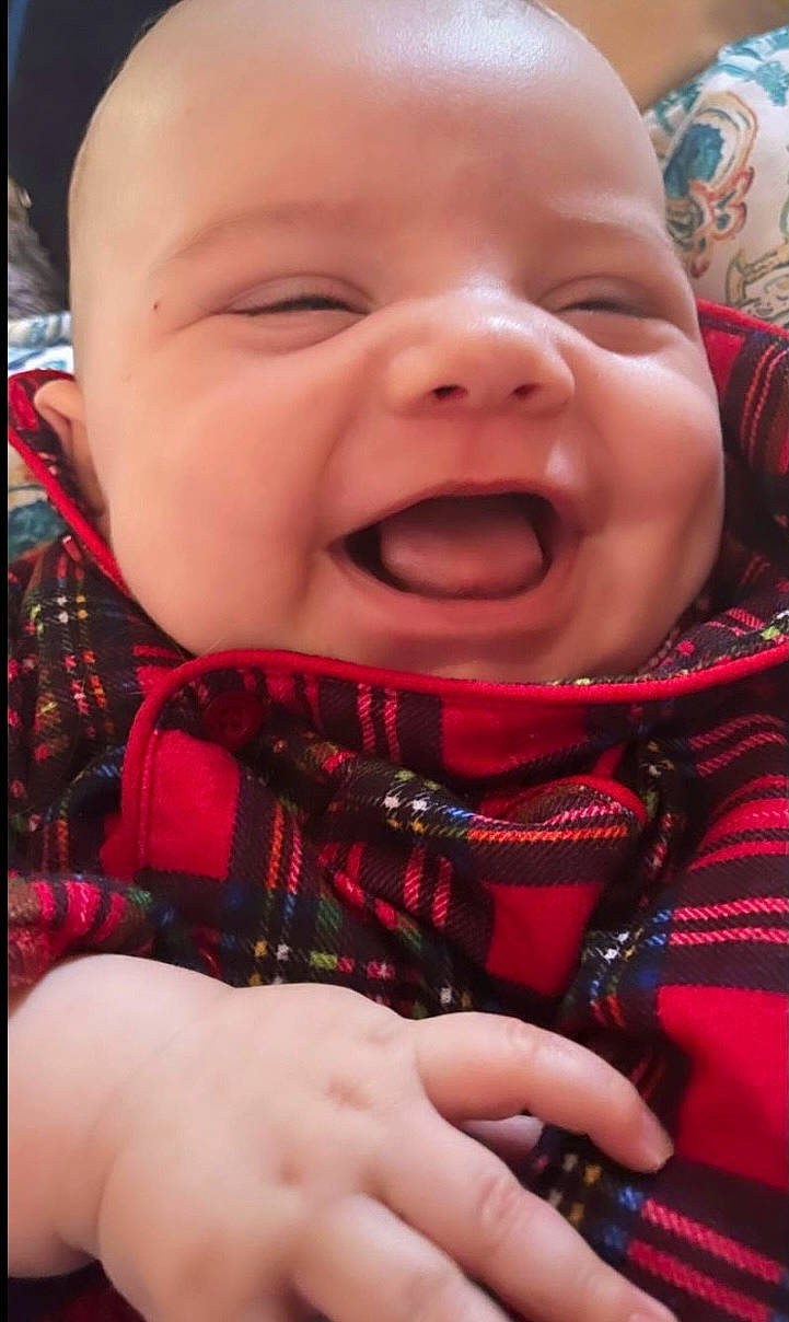 Bruce is registered to the contest to win money with this photo: baby, baby_laughing, baby_toddler_clothing, cheek, comfort, facial_expression, finger, gesture, happy, iris, lip, mouth, nose, person, pink, red, skin, sleeve, smile, textile