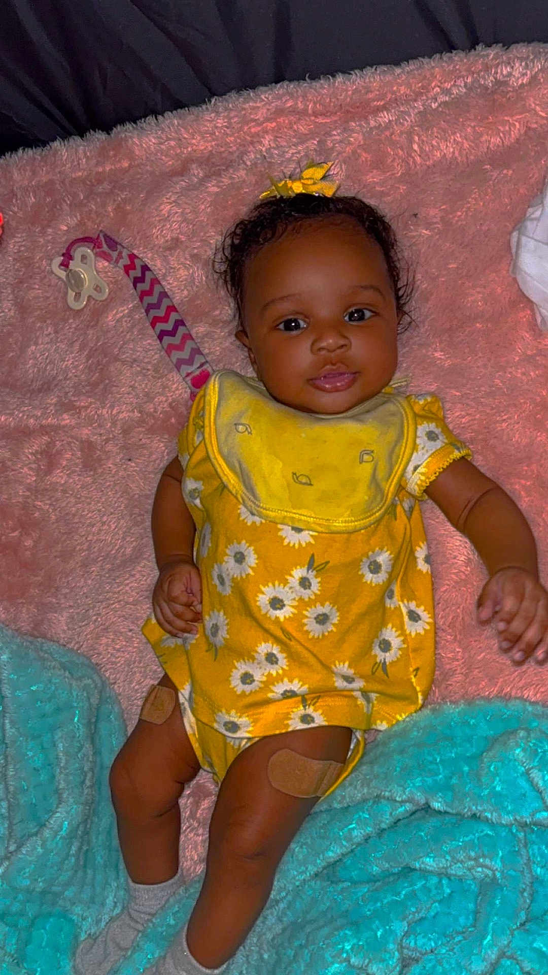 Kacey is registered to the contest to win money with this photo: accessories, baby, blanket, clothing, couch, cushion, dress, face, furniture, happy, head, homedecor, indoors, person, photography, portrait, quilt, sitting, smile, toy