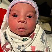 Littlejoe is registered to the contest to win money with this photo: newborn, baby, infant, swaddle, hospital_blanket, striped_cap, cap, face, eyes, nose, mouth, close_up, portrait, indoor, hospital, blanket, footprint_pattern, skin, cozy, adorable