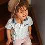 toddler, child, curly_hair, hat, smiling, stairs, pacifier, clothing, shorts, shirt, footwear, indoors, wood, happy, person, baby, casual, cute, sitting, accessory