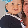 toddler, child, smiling, cap, blue_cap, sailor_outfit, navy_clothing, baby, person, adult, face, portrait, happy, indoor, closeup, cute, headwear, holding, parent, casual_clothing