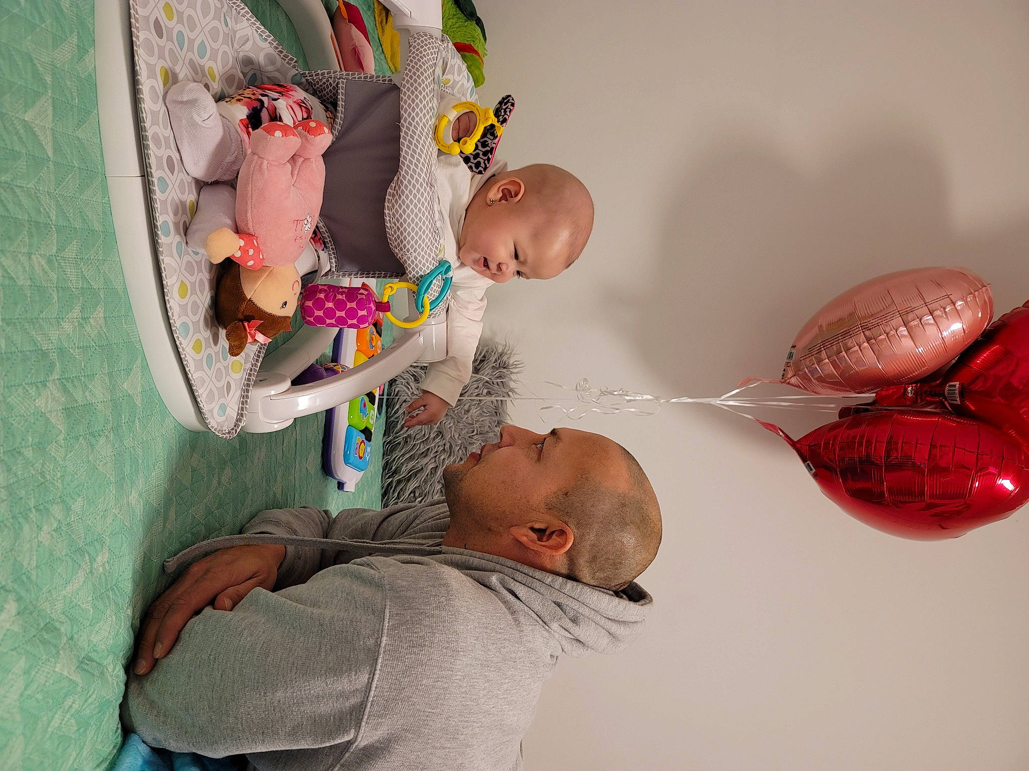 Nicole is registered to the contest to win money with this photo: art, baby, baby_products, balloon, child, event, fun, happy, leisure, organism, party_supply, person, pink, play, room, sitting, t_shirt, textile, toddler, toy