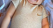 Josiah joined the competition — help win amazing prizes! baby, infant, child, smiling, sleeping, portrait, face, indoors, bedding, blanket, pacifier, clothing, shirt, pants, nike, happy, lying_down, cozy, close_up, photography