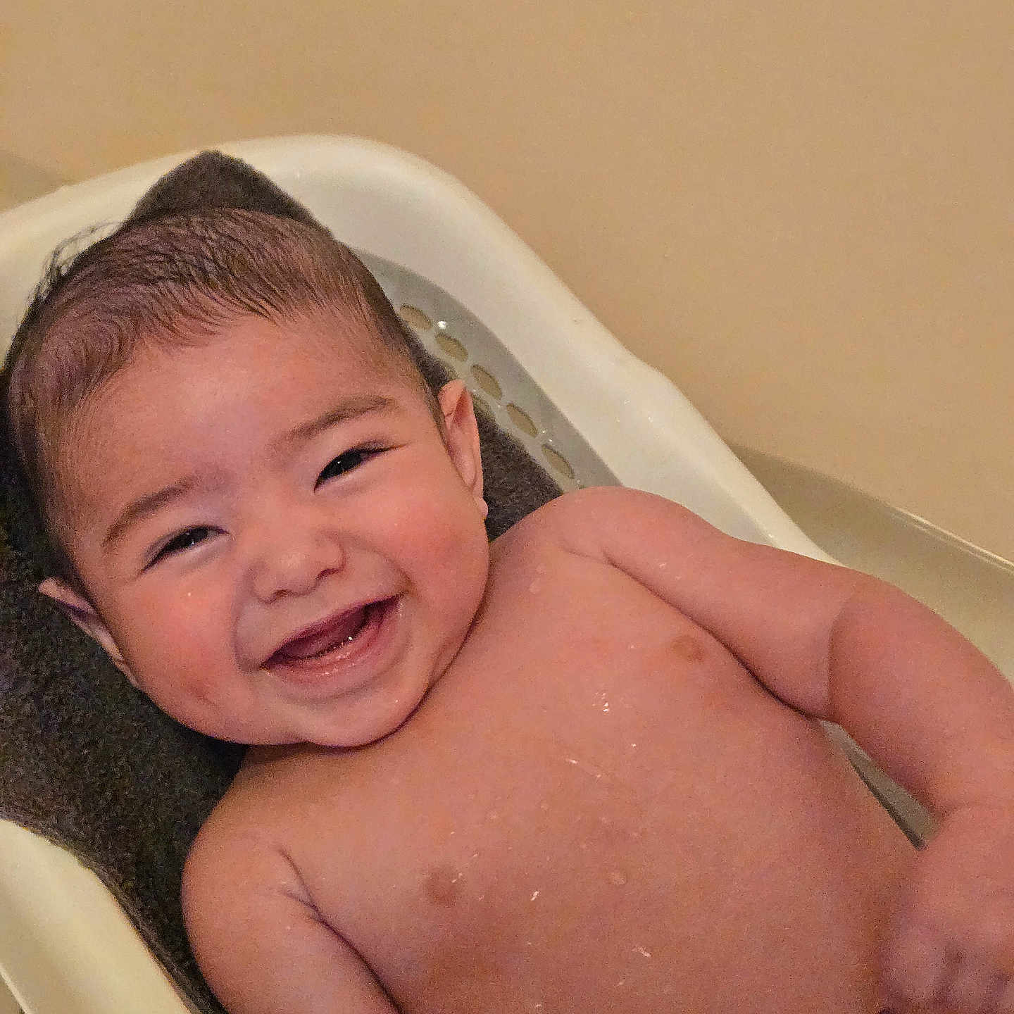 Josiah is registered to the contest to win money with this photo: baby, infant, child, smiling, happy, portrait, face, high_chair, indoor, warm_lighting, bare_chested, wet_skin, short_hair, brown_hair, eyes, mouth, arms, sitting, closeup, photography