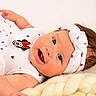 baby, infant, smile, headband, white_clothing, minnie_mouse, cute, happy, closeup, portrait, soft_blanket, child, lying_down, adorable, skin, face, small_hand, newborn, indoors, light_background