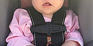 Baylor is registered to the contest to win money with this photo: baby, bare_feet, black_bow, car_seat, child, curious_expression, cute, face, hands, harness, headband, indoors, infant, legs, pacifier, pink_clothing, portrait, red_button, safety_strap, seat