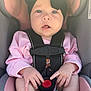 Baylor is registered to the contest to win money with this photo: baby, infant, car_seat, black_bow, headband, pink_clothing, harness, safety_strap, red_button, pacifier, bare_feet, curious_expression, child, cute, indoors, seat, hands, legs, face, portrait