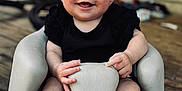 Baylor joined the competition — help win amazing prizes! baby, smiling, infant, seat, foot, hand, wood_floor, porch, black_clothing, face, happy, child, indoors, skin, small_toes, molded_seat, expression, person, cute, sitting