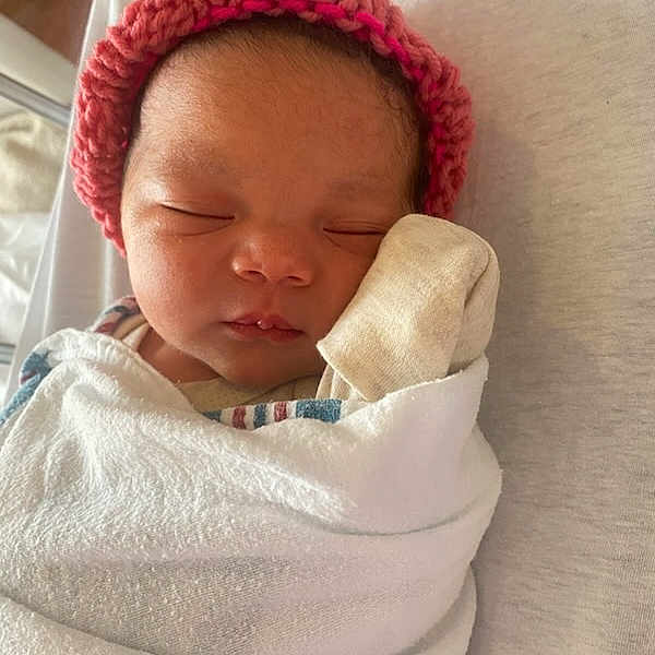 Lelani is registered to the contest to win money with this photo: baby, bed, blanket, closeup, cozy, cute, face, hat, indoors, infant, mitten, newborn, peaceful, portrait, rest, skin, sleeping, soft, tiny, wrapped