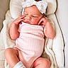 baby, sleeping, infant, onesie, headband, bow, pink, white, blanket, cushion, cozy, cute, child, resting, soft, newborn, indoors, comfortable, peaceful, portrait