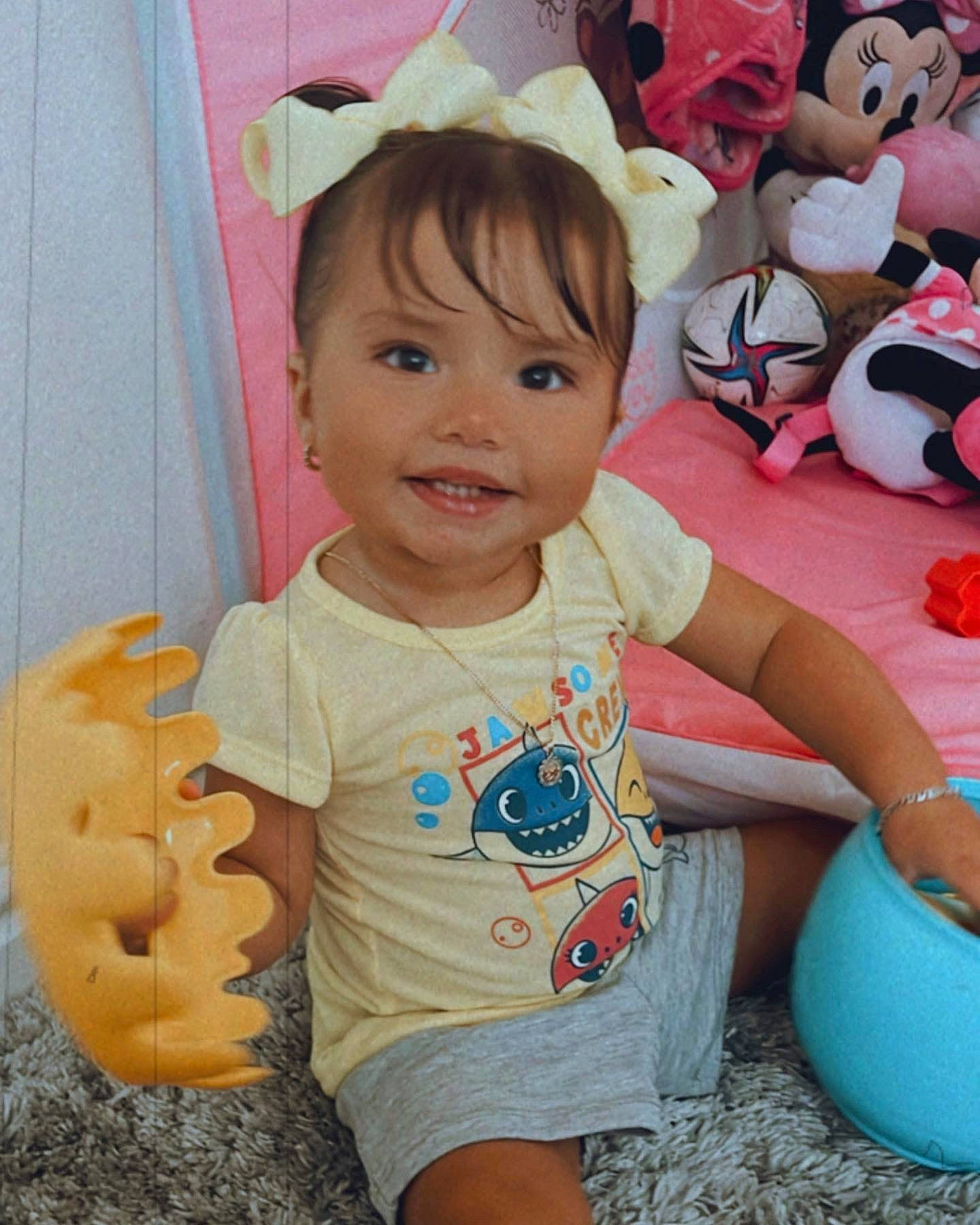 Rosalie is registered to the contest to win money with this photo: baby, baby_toddler_clothing, child, facial_expression, fun, happy, headgear, joy, leg, leisure, mammal, person, pink, play, shorts, skin, smile, stuffed_toy, t_shirt, textile