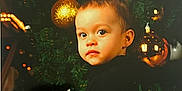 Maïwenn participe au concours pour gagner de l'argent avec cette photo : black_clothing, celebration, child, christmas_tree, curious, cute, decorations, face, festive, festivity, golden_ball, hair_buns, holiday, holiday_season, indoor, ornament, portrait, smile, toddler, young_child